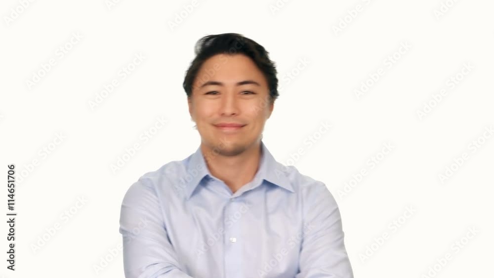 Trendy attractive man wearing a light blue shirt, smiling and walking towards camera in front of a white background. Trendy attractive man wearing a light blue shirt, smiling and walking towards camera in front of a white background.