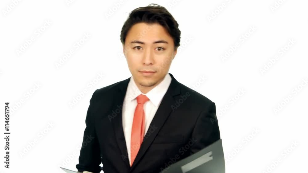 Attractive businessman walking holding a clipboard with documents, reading. Turns and looks at camera. White background. Attractive businessman walking holding a clipboard with documents, reading. Turns and looks at camera. White background.