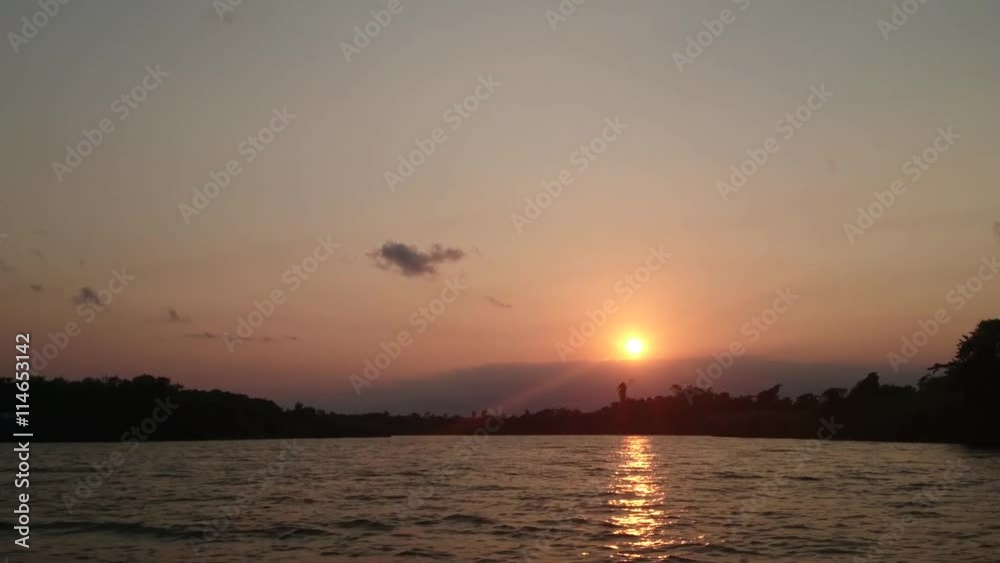 Monkey River, Belize - May, 2016 - Sunset at Monkey River, a rural village suffering from erosion and rising water level. Monkey River, Belize - May, 2016 - Sunset at Monkey River, a rural village suffering from erosion and rising water level.