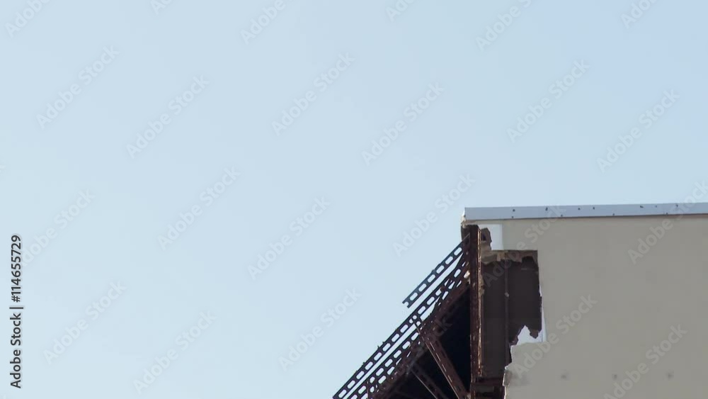 Craning down from roof to base of building damaged by a hurricane Craning down from roof to base of building damaged by a hurricane