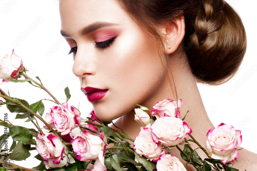 Portrait of young beautiful woman with stylish make-up and colorful roses around her face Portrait of young beautiful woman with stylish make-up and colorful roses around her face