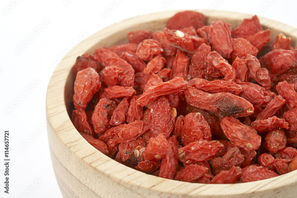 goji berry in wooden cup on white background. goji berry in wooden cup on white background.