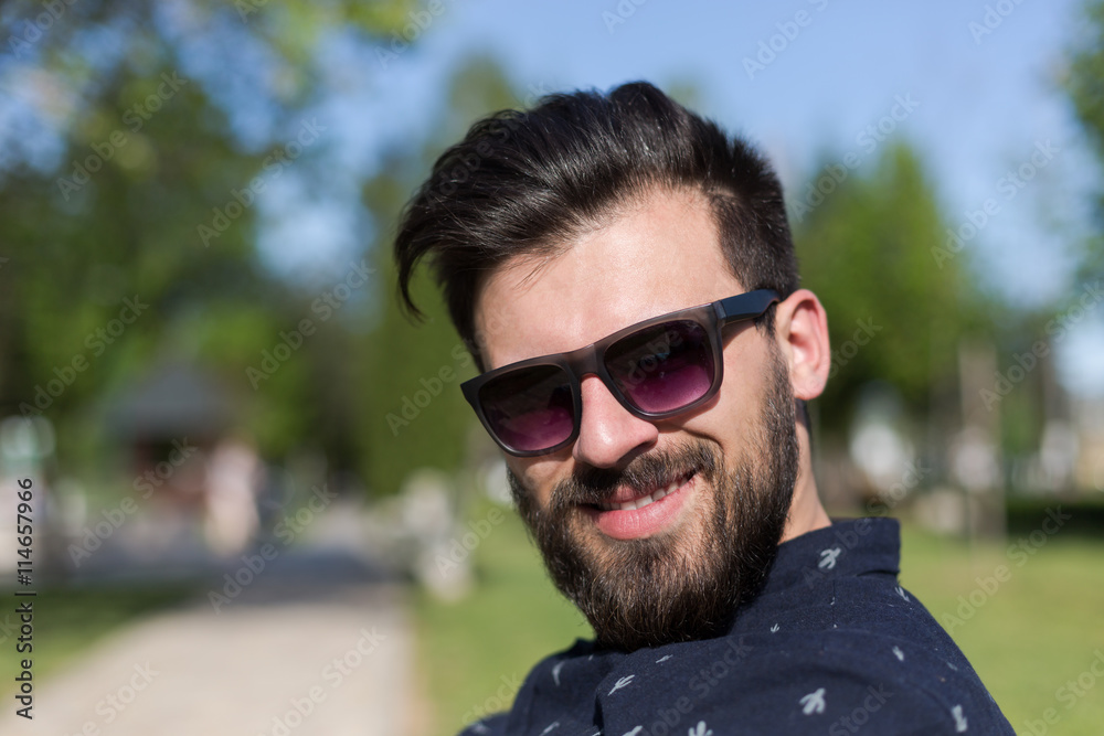 Young man relaxing on park bench on a summers day Young man relaxing on park bench on a summers day