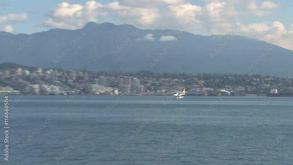 Water airplane landing in harbor Vancouver, Canada Water airplane landing in harbor Vancouver, Canada
