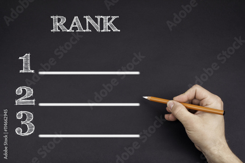 Hand with a white pencil writing: Rank blank list photo