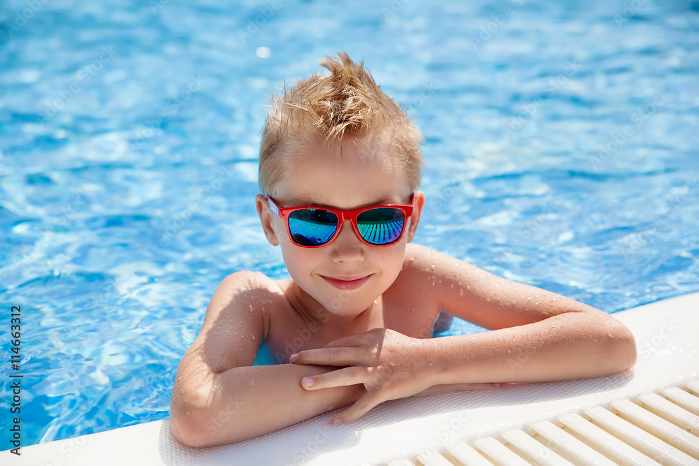 portrait of young caucasian boy in swimming pool