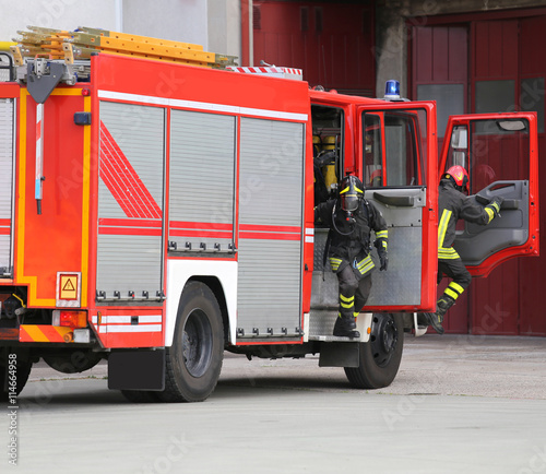 fire engine with many firefighters and equipment for fighting fi