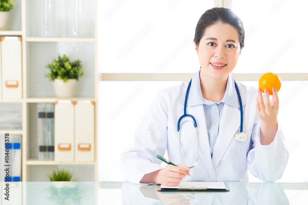Young asian nutritionist doctor writing diet plan Young asian nutritionist doctor writing diet plan