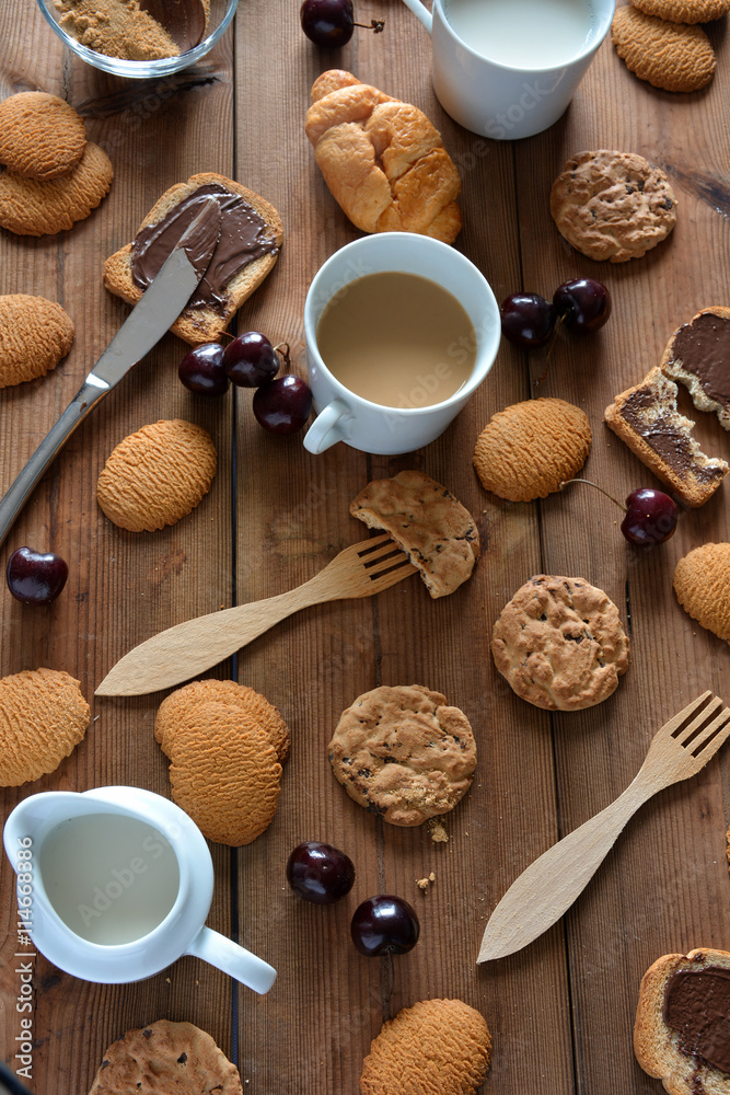 Few chocolate cookies and biscuits with milk Few chocolate cookies and biscuits with milk