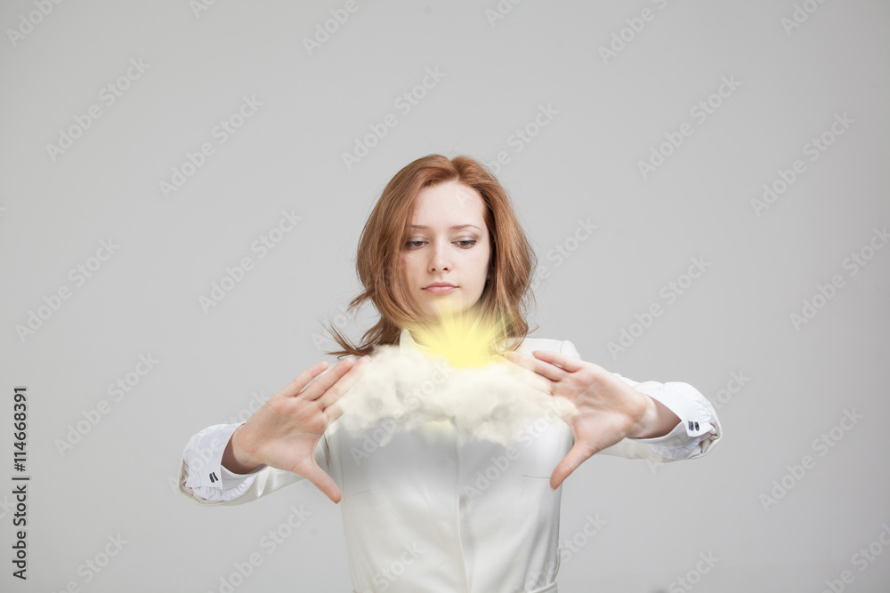Young woman and sun shining out from behind the clouds, cloud computing or weather concept Young woman and sun shining out from behind the clouds, cloud computing or weather concept