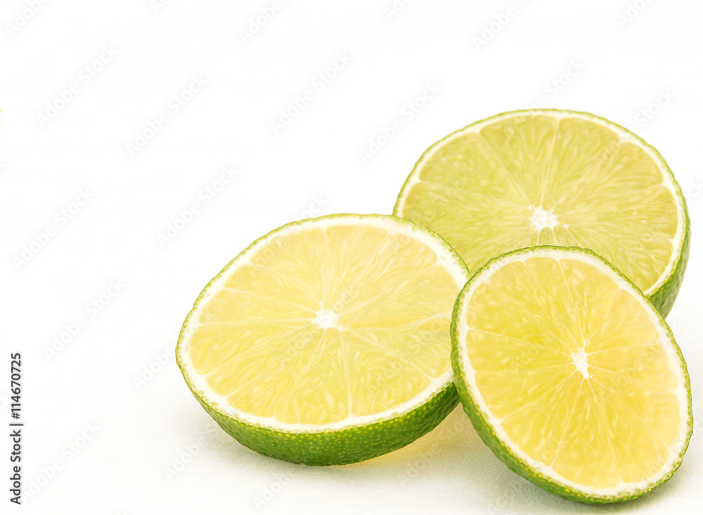 Three slices of lime on white background in bottom right corner Three slices of lime on white background in bottom right corner