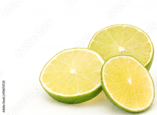 Three slices of lime on white background in bottom right corner