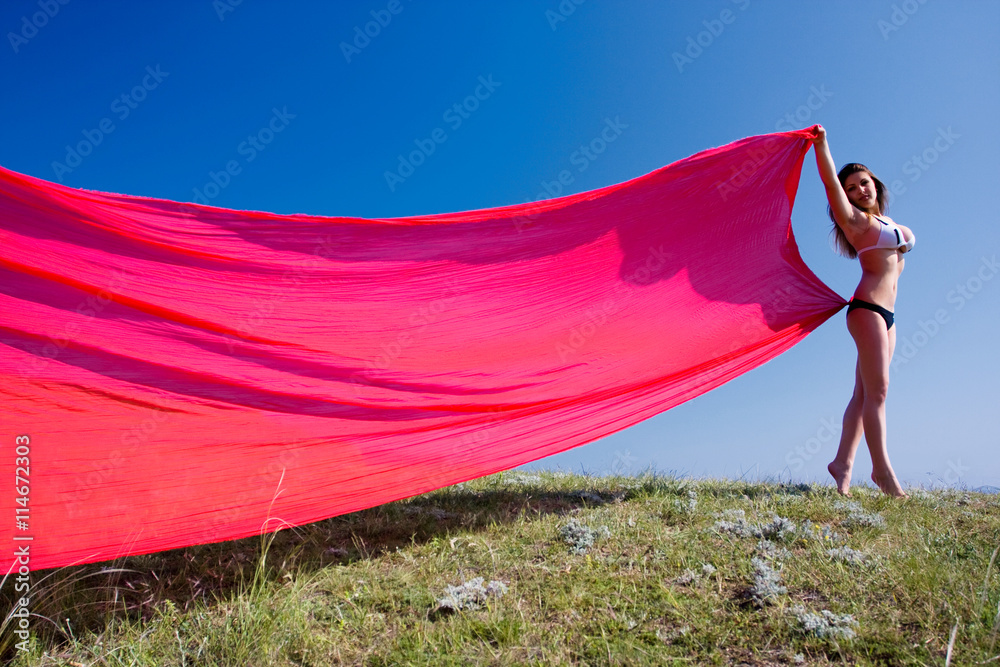 woman with red material and nature