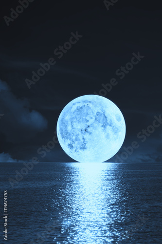Moonrise over sea / ocean. photo