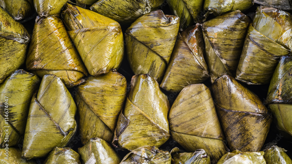 Macro detail of sticky rice covered in banana leaf or 