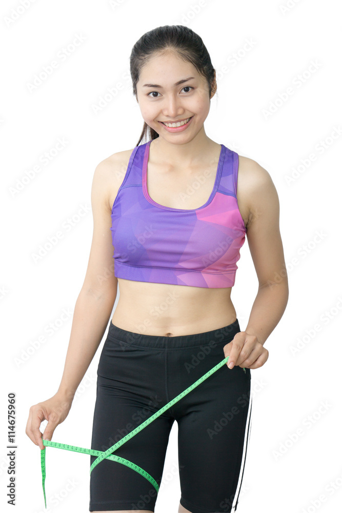 Woman in sport bra measuring her body with tape isolated on whit Woman in sport bra measuring her body with tape isolated on whit