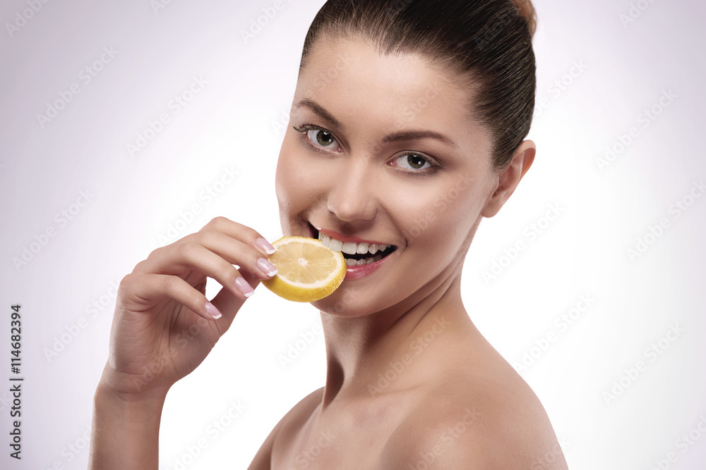 Natural woman eating fresh lemon Natural woman eating fresh lemon
