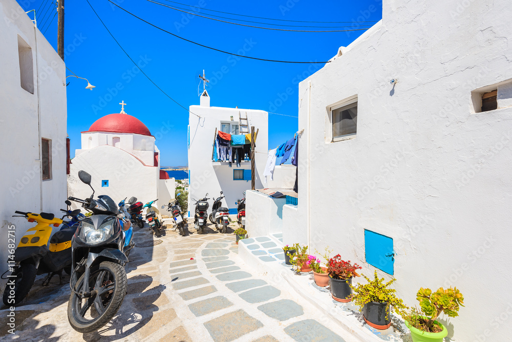 Fototapeta premium MYKONOS TOWN, GREECE - MAY 16, 2016: Scooters parked on street in Mykonos town on island of Mykonos, Cyclades, Greece