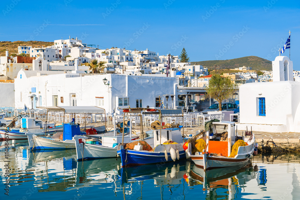 A view of Naoussa port with Greek style church and traditional fishing boats, Paros island, Cyclades, Greece