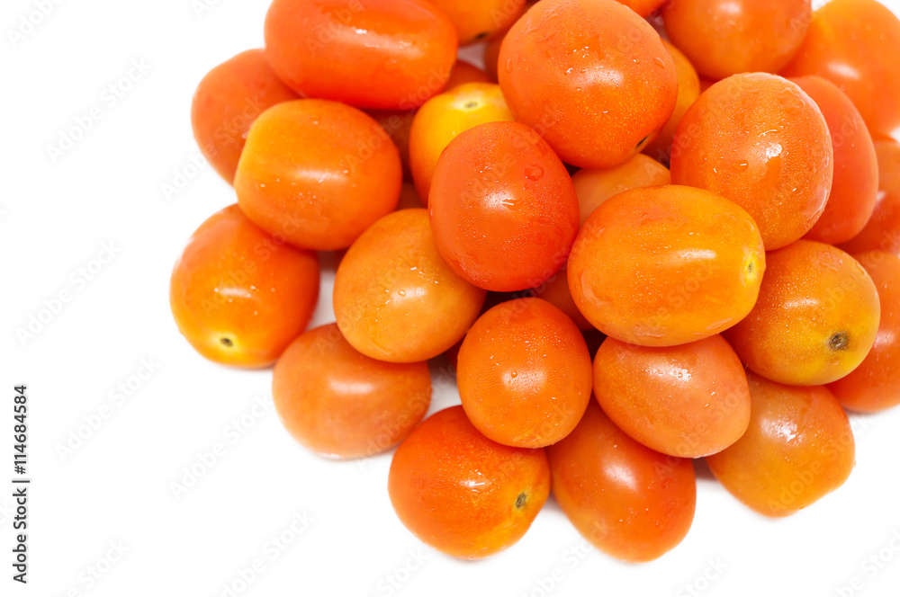 Small red tomatoes on white background.