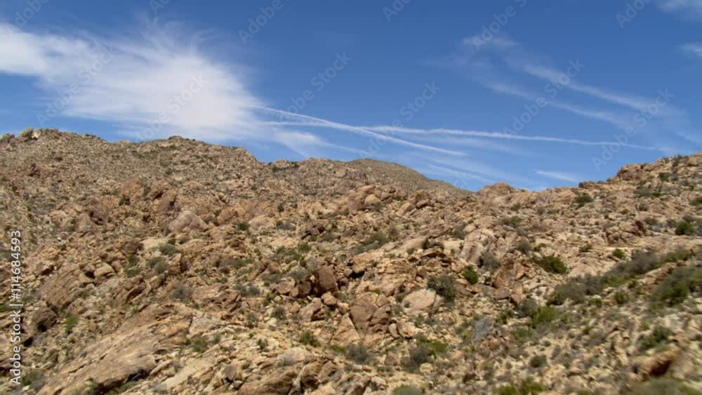 Close flight over rocky hills to wide view of desert landscape Close flight over rocky hills to wide view of desert landscape