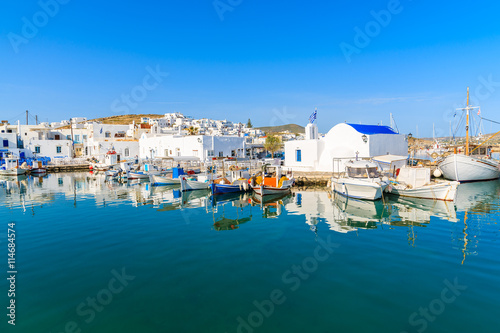 Fototapeta Naklejka Na Ścianę i Meble -  A view of Naoussa port with Greek style church and traditional fishing boats, Paros island, Cyclades, Greece