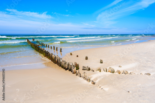 A view of beautiful beach with breakwaters in Debki village, Baltic Sea, Poland photo