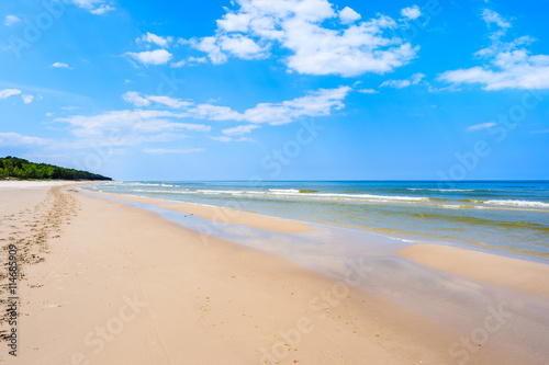 A view of white sand beach and blue Baltic Sea, Bialogora coastal village, Poland