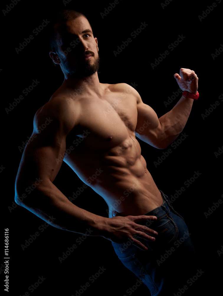 Fit man showing his strong muscles Fit man showing his strong muscles