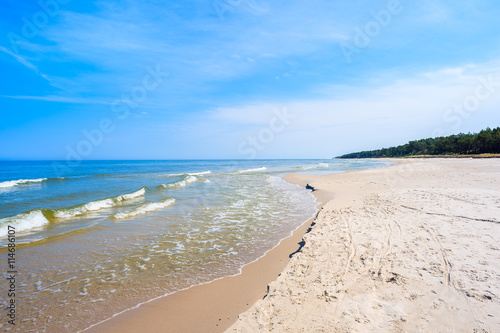 A view of white sand beach and waves of blue Baltic Sea  Bialogora coastal village  Poland