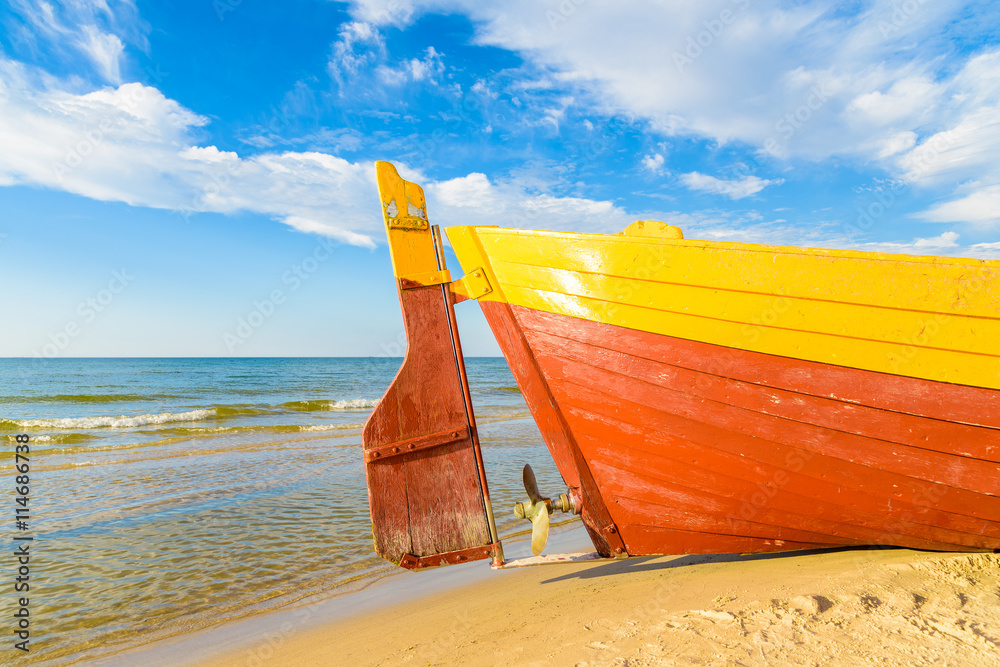 Typical fishing boats on a beach in Debki coastal village at sunset time, Baltic Sea, Poland Typical fishing boats on a beach in Debki coastal village at sunset time, Baltic Sea, Poland