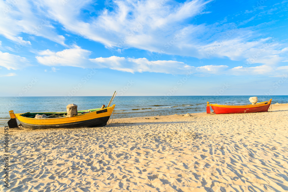 Fototapeta premium Typical fishing boats on a beach in Debki coastal village at sunset time, Baltic Sea, Poland