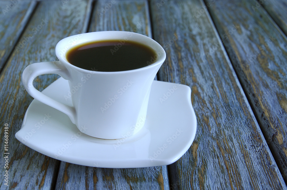 Cup of fresh espresso on table