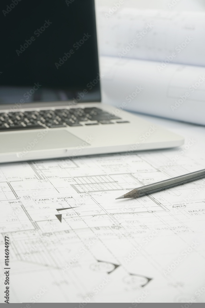 black pencil and computer laptop on architectural drawing paper for construction black pencil and computer laptop on architectural drawing paper for construction