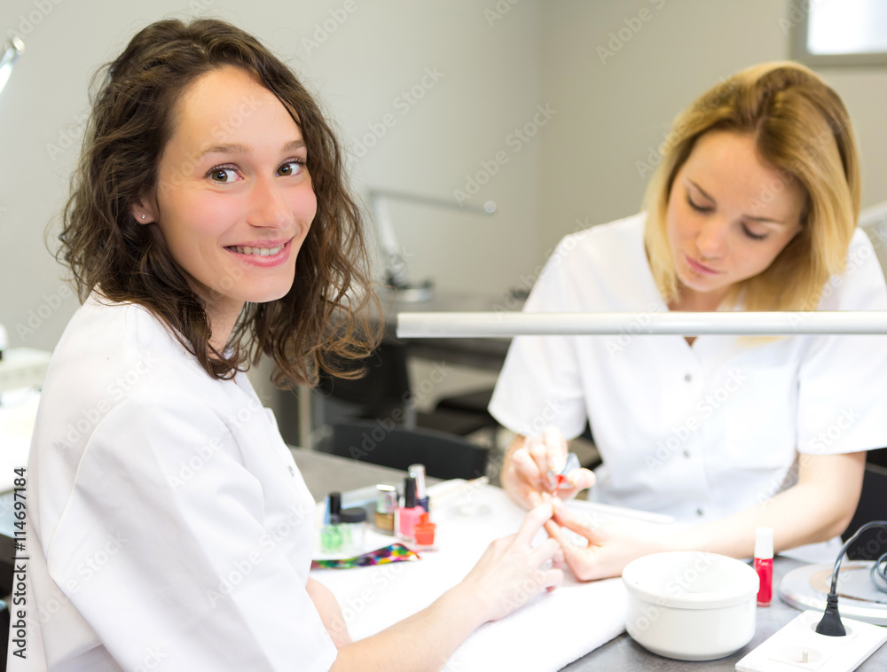 Young attractive beautician students practising during courses