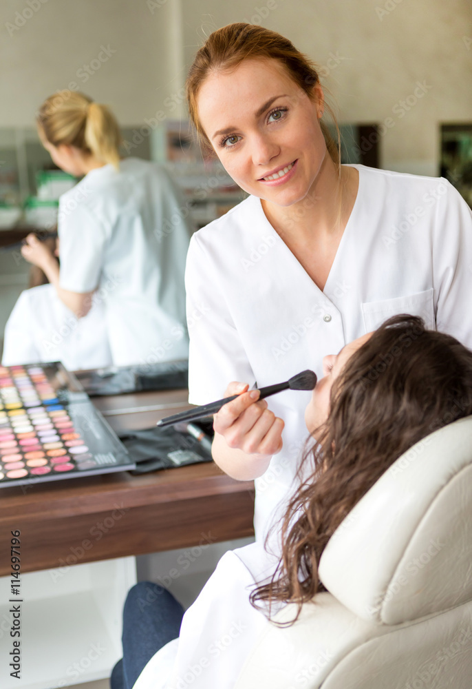 Obraz premium Two young beautician students working during make up classes