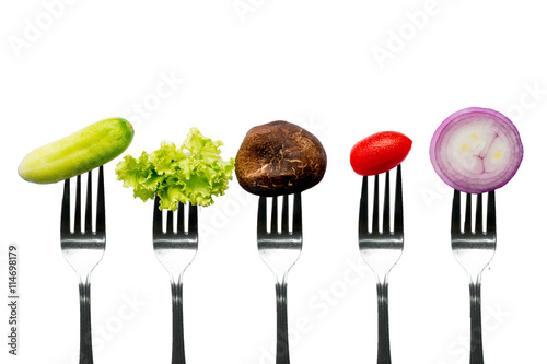 Vegetables on fork isolated on white