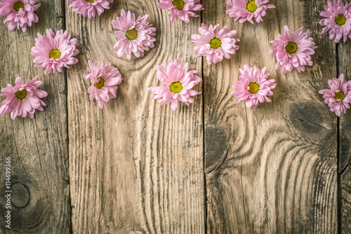 Composition of pink flowers on the wooden table top view