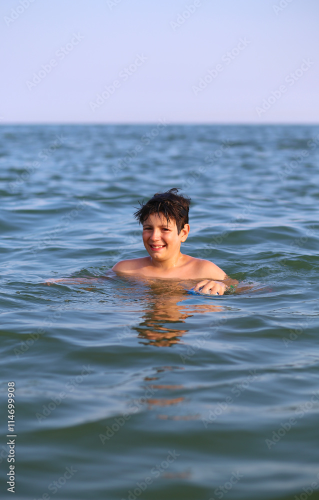 boy  plays in seawater during summer vacation