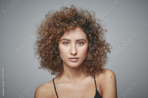 Portrait of redheaded woman with curly hair photo