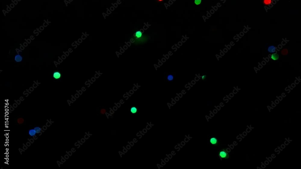 Small red, green, and blue lights randomly flashing in darkness, at first rapidly and then more slowly Small red, green, and blue lights randomly flashing in darkness, at first rapidly and then more slowly