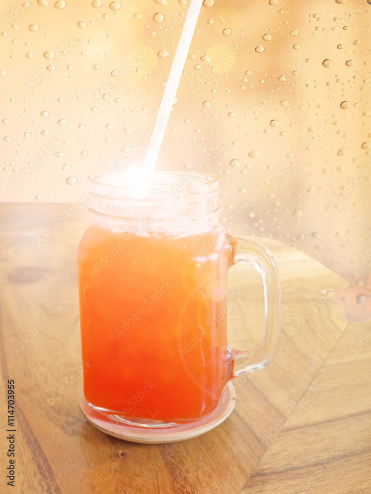 Soft and blur glass of strawberry soda summer beverage with soft light on wood table Soft and blur glass of strawberry soda summer beverage with soft light on wood table