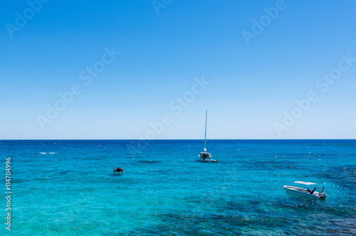 Photo of sea in protaras, cyprus island with boats and immaculate water.
