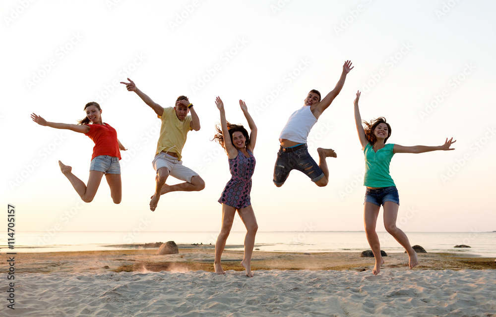 smiling friends dancing and jumping on beach smiling friends dancing and jumping on beach