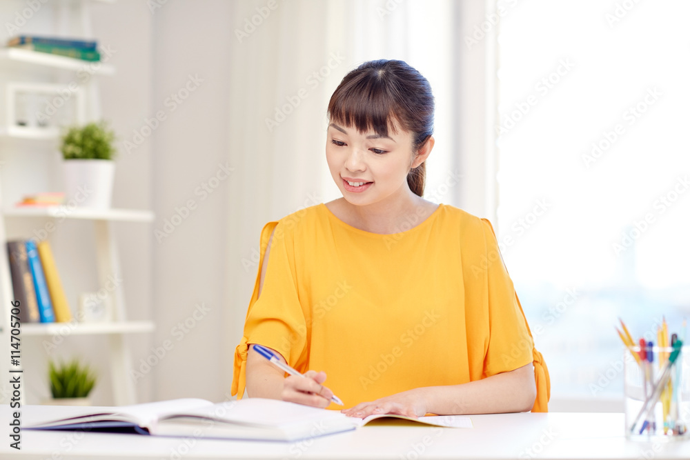 happy asian young woman student learning at home