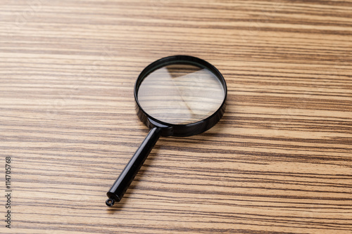 magnifying glass on the wooden background