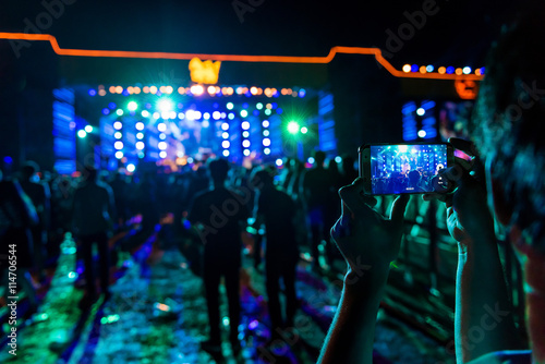 People holding their smart phones shooting video or photo.