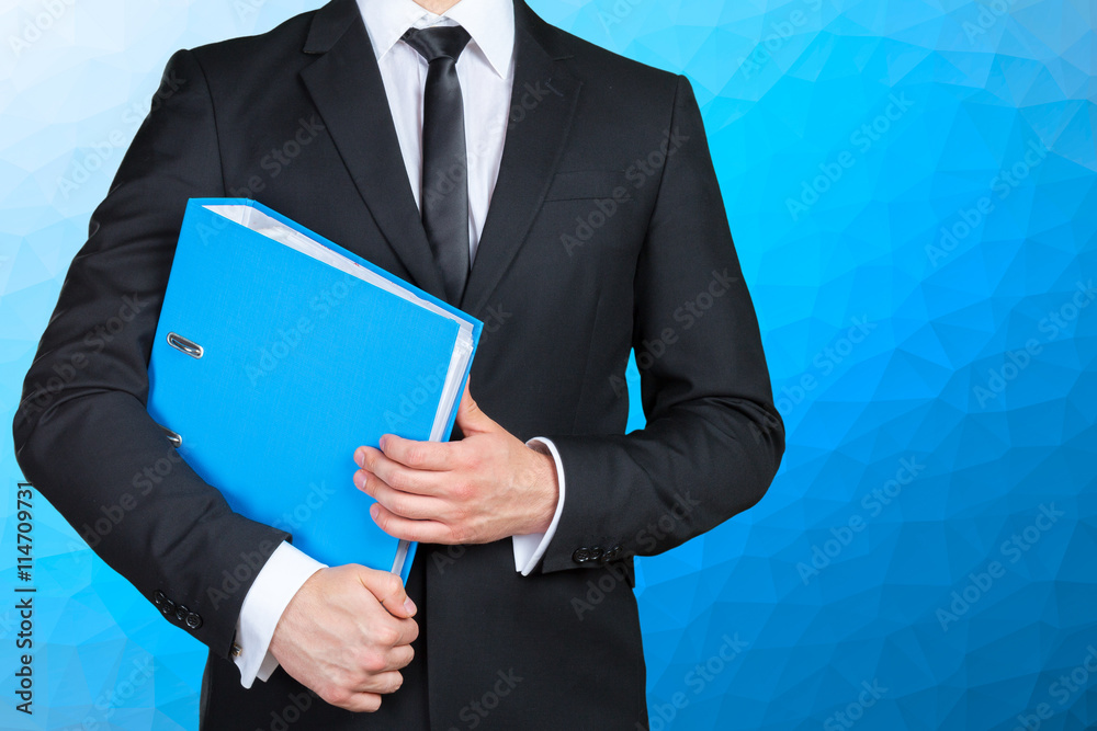 Confident businessman holding a document folder Confident businessman holding a document folder
