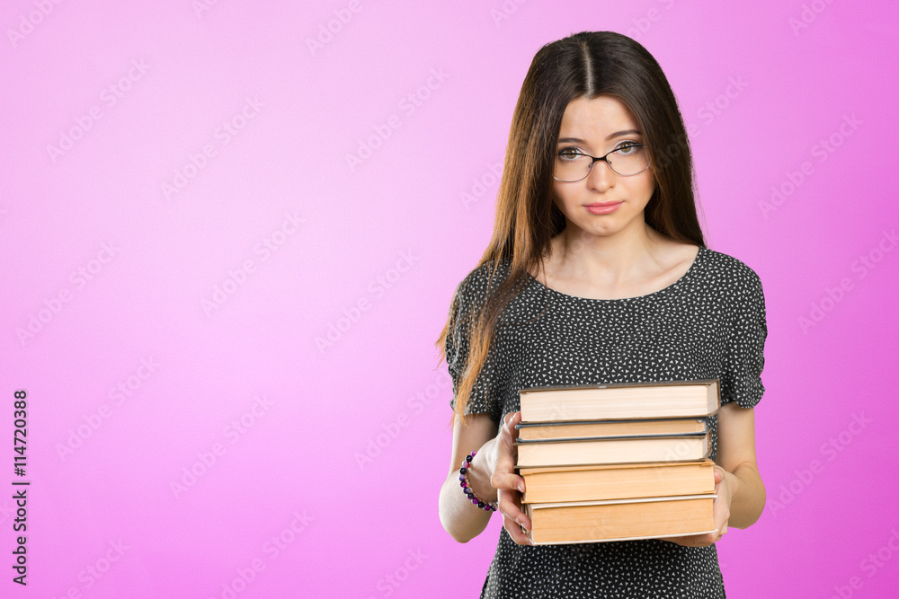 Smiling business woman holding stack of books Smiling business woman holding stack of books