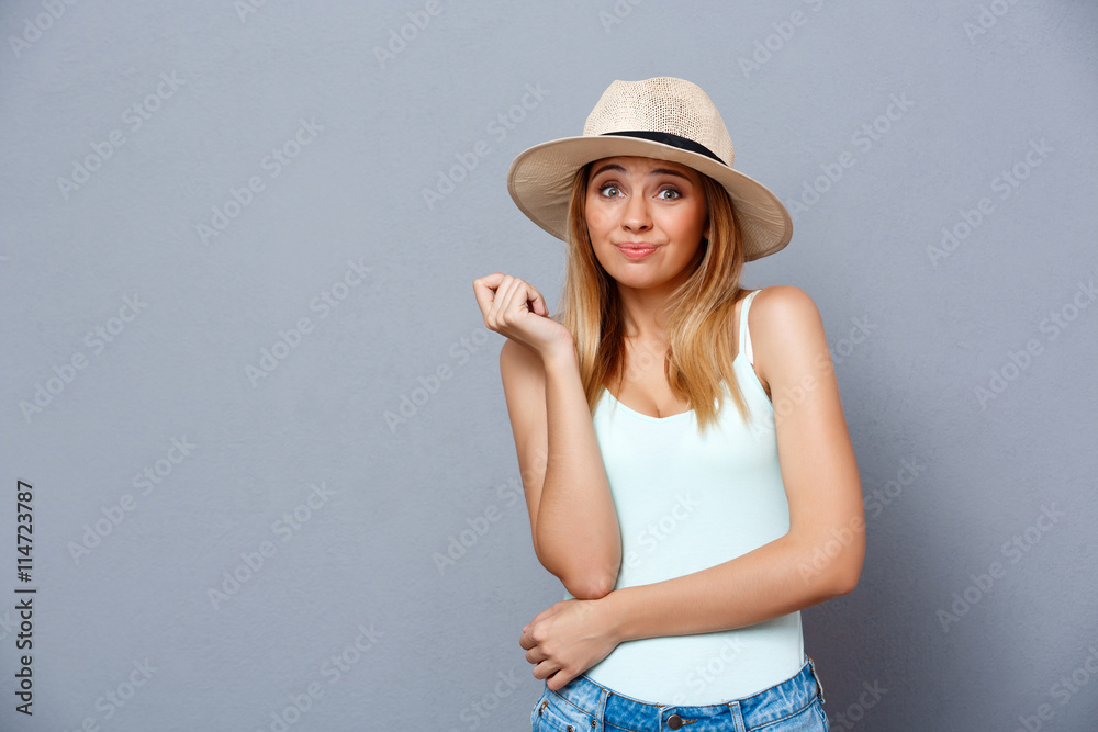 Portrait of young beautiful girl over gray background. Copy space. Portrait of young beautiful girl over gray background. Copy space.